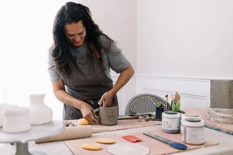 A local potter shaping clay at a worktable