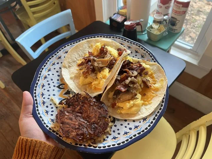 Two breakfast tacos with egg, bacon and mushrooms